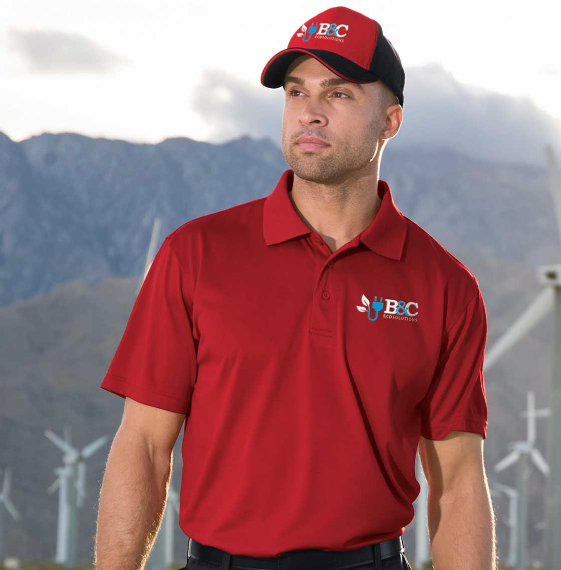 Man wearing hat and polo shirt featuring embroidered logos